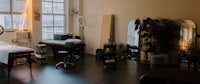 a room with a massage table and chairs
